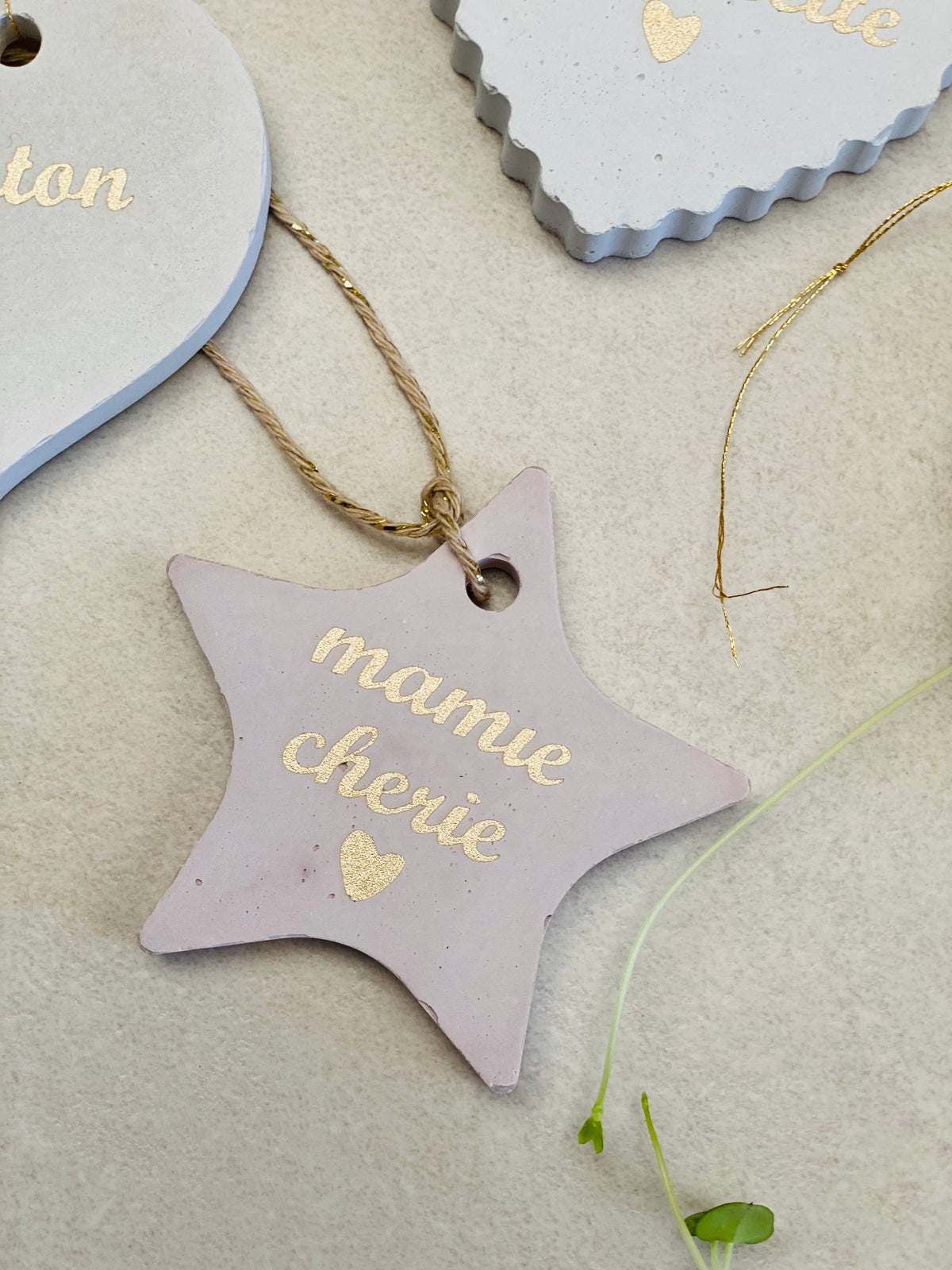 Une suspension rose en forme d’étoile avec une vinyle doré écrit mamie chérie 